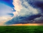 storm clouds over green fields