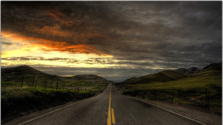 blacktop road through hilly countryside hdr - hills, sundown, blacktop, clouds, hdr, grass, road