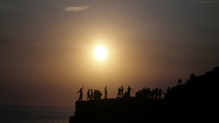 gathering on the seashore - haze, shore, people, cliff, sea, sun