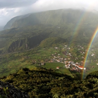 view from above of a rainbow over seaside village