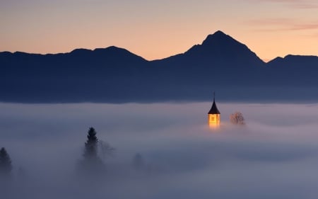 church tower peeking through morning fog - silhouette, church, light, fog, mountains