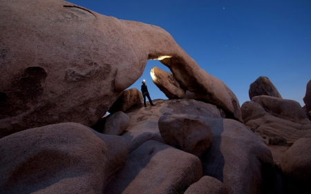 explorer under a rock arch - explorer, rocks, stars, arch