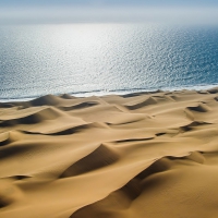 flat ocean and wavy sand