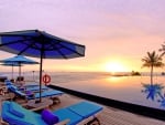 infinity pool on a beach at sunset