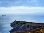 ship passing lighthouse on the point