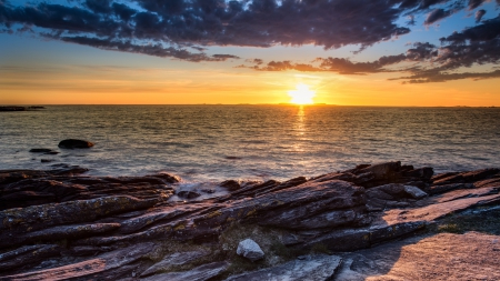 spectacular sunset over rocky seashore