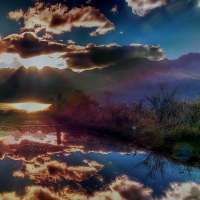 mirror pond in sun rays at sunrise