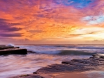 wonderfully colored sky over rocky shore