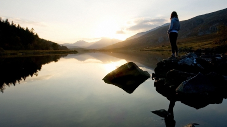 view of a beautiful lake at sunrise - woman, lake, sunrise, rocks