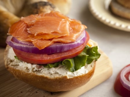 Salmon Bagel Sandwich - bread, abstract, bagel, delicious, food, salmon, orange, sandwich, lettuce, purple, green, tomato, fish, onion