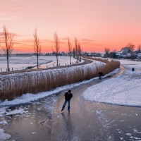 ice skating on a frozen river in holland