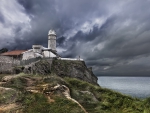 brick lighthouse under stormy sky hdr