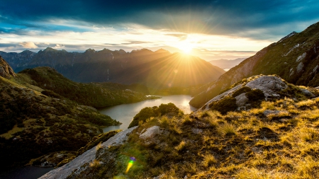 magnificent fiordland sunrise in new zealand - mountains, sunrise, shrubs, rocks, fiord