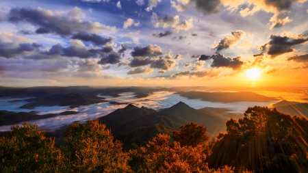 sunset over cloud covered mountain range - clouds, trees, sunset, autumn, mountains