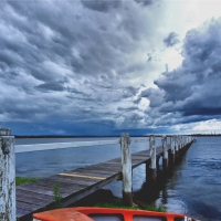 stormy clouds over a bay pier