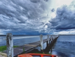 stormy clouds over a bay pier