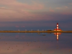 beautiful red and white lighthouse reflected