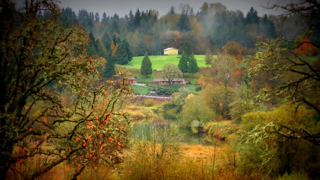 focused view of riverside homes - houses, trees, hills, river, grass