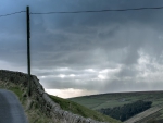 stone wall along a hill road hdr