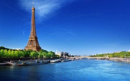 The Eiffel Tower - sky, water, la tour eiffel, france, the eiffel tower, trams, river, blue, seine, bridge