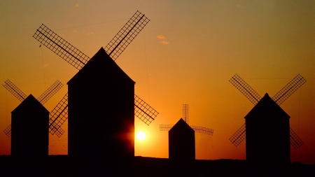 silhouettes of windmills at sunset - orange, windmills, silhouettes, sunset