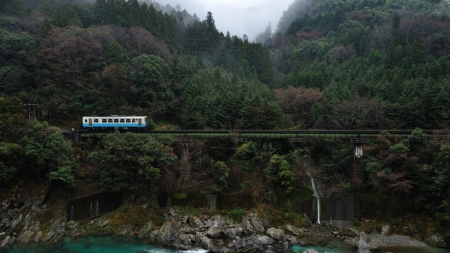 lone train car in beautiful nature - train, tracks, waterfalls, pond, forest