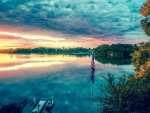 flag pole on a dock in a beautiful lake hdr