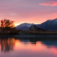 stone church on lakeside at sunset