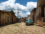 old cars on a street in a cuban barrio