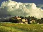 magnificent clouds over tuscan farm