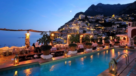 spectacular hotel in a seaside town - restaurant, town, cliff, pool, sea, dusk, lghts