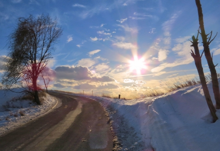 A Country Road Sunset in Winter - clouds, winter, road, snow, travel, path, sunset, nature, country, sun, sky