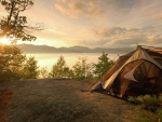 tent on a lake shore at sunrise