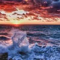 sea waves breaking ashore at sunset hdr