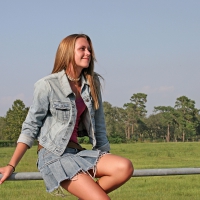 Cowgirl On A Fence