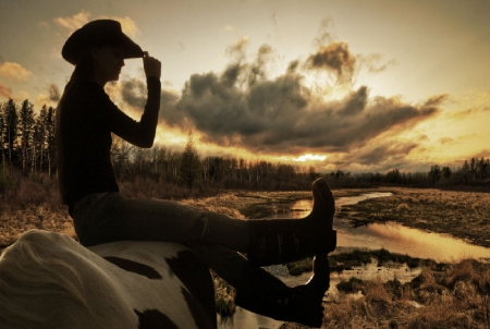 Cowgirl On A Dreary Day - style, girls, rocks, women, beatiful, model, models, hats, cowgirl, fun, sunset, boots, fashion, western, silhouette, outdoors, rivers, river basin, clouds, female