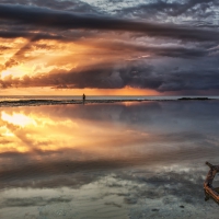 fisherman on an australian beach at sunset