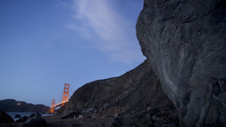 golden gate bridge from a rocky shore - shore, bridge, dusk, bay, rocks