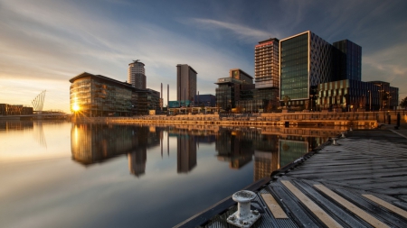 reflected sunrise on a city waterfront - wharf, sunrise, waterfront, city, reflection