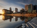 reflected sunrise on a city waterfront