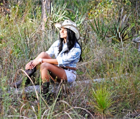 Cowgirl Beauty - fun, female, boots, class, fashion, hats, western, cowgirls, style, famous, women, trees, beautiful, photography, models, logs, rodeo, outdoors, ranch