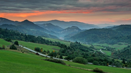 road down to a green valley - mountains, road, valley, sunset, green