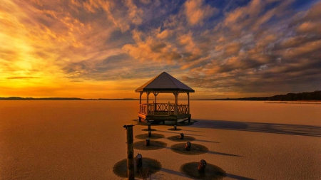 arbor on a beach at low low tide - pillars, clouds, sunset, arbor, beach