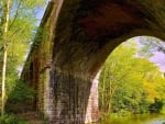 old brick bridge over a canal in sunshine