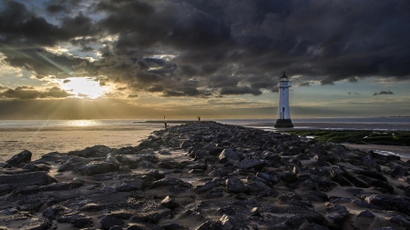 beach lighthouse by a long stone wharf - clouds, wharf, lighthouse, beach, sea, rocks