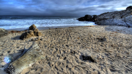 fabulous beach scape hdr - rocks, driftwood, sunbeams, beach, sea, waves, hdr