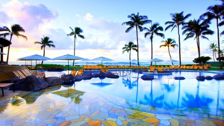 beautiful resort pool in kauai hawaii - umbrellas, trees, tiles, sea, pool, reort