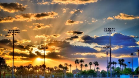 wondrous sunset over athletic fields hdr - lights, towers, sports, clouds, rays, sunset, park, hdr