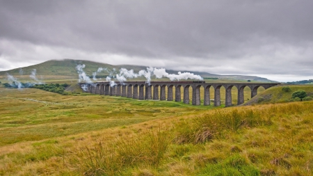 old steam train on an old prairie bridge