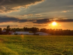 sunset over a farm in spring